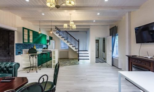 grodno-belarus-august-2019-luxure-hall-interior-loft-flat-grey-style-design-with-green-kitchen-fireplace-chester-sofa-with-stairs_97694-5249