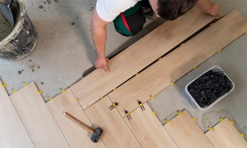top-view-man-tiling-floor_23-2149344001